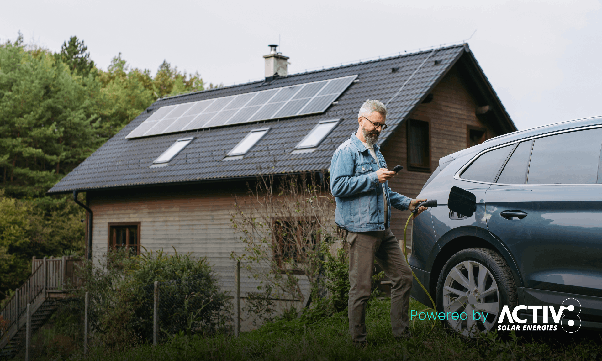 man charging his car with solar panels on roof