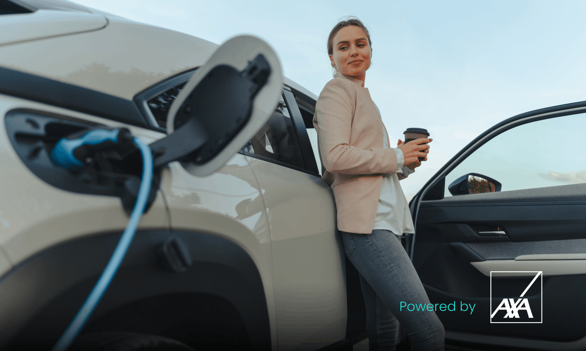 woman drinking coffee while charging her car