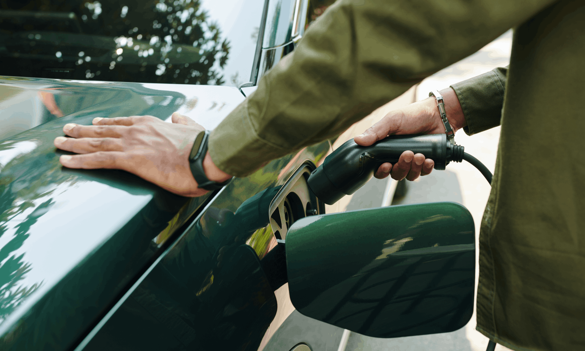 green car being plugged in to charge