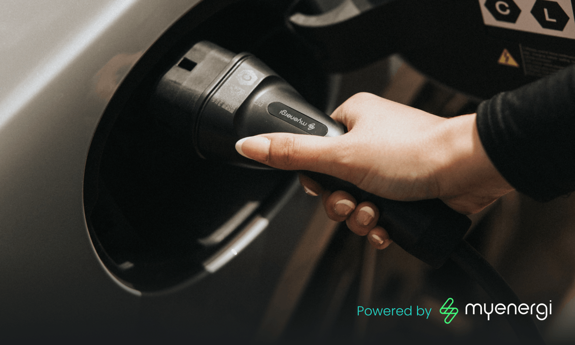hand plugging in myenergi electric vehicle home charger