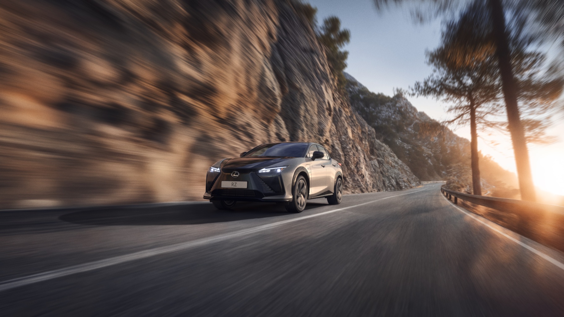 Lexus RZ in silver driving on mountain road