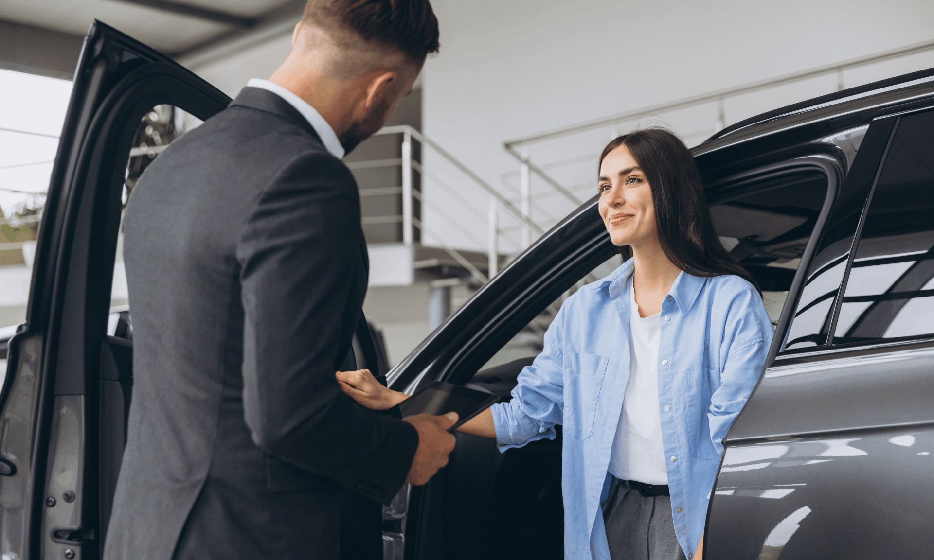 woman in car looking at sales man